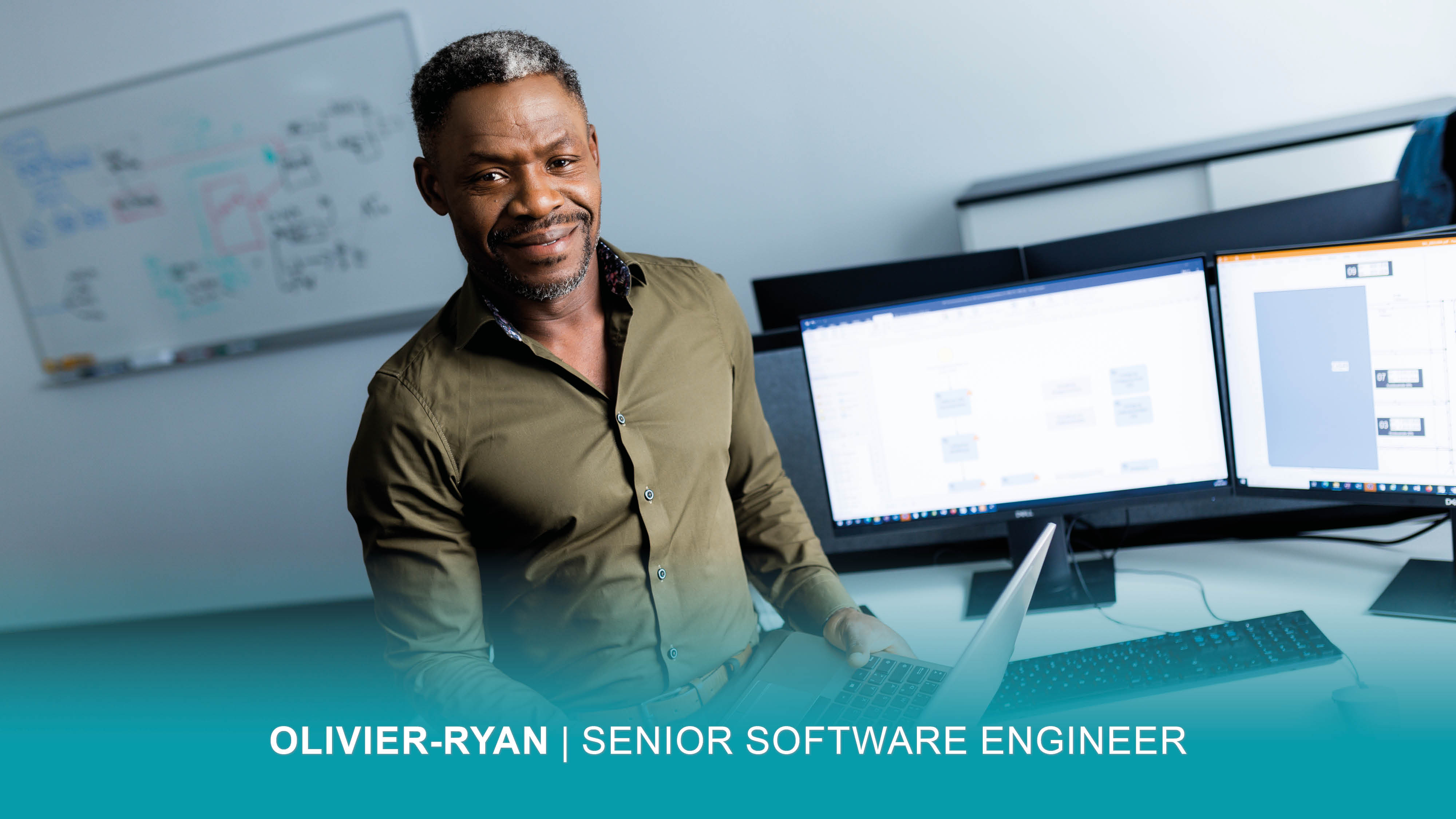 Software Engineer Oliver-Ryan sits at his workstation